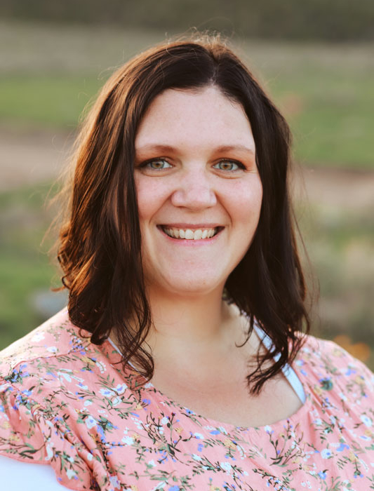 A woman in a pink shirt with brown hair, associated with Bonneville Family Practice.