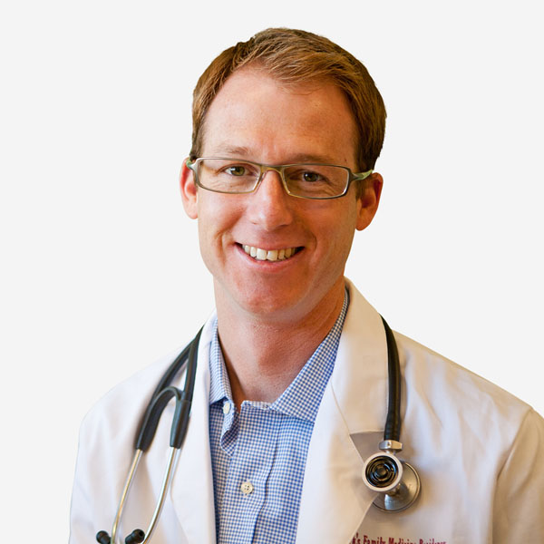 A professional man in a white coat and glasses is seen at Bonneville Family Practice, symbolizing trust in healthcare services.