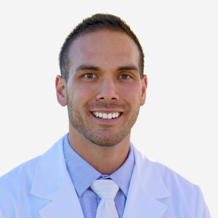 A male doctor wearing a white coat and tie at Bonneville Family Practice, prepared to provide quality healthcare services.