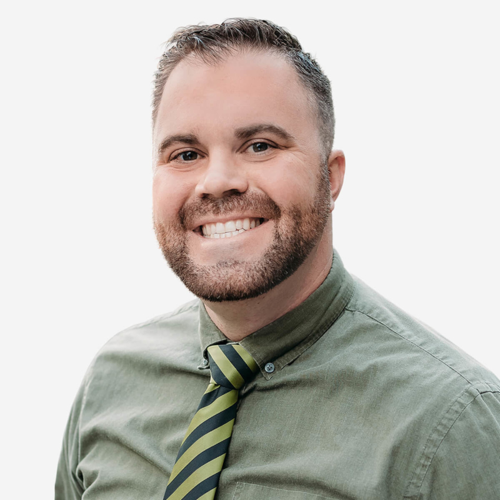 A smiling man with a beard wearing a green tie, representing Bonneville Family Practice.