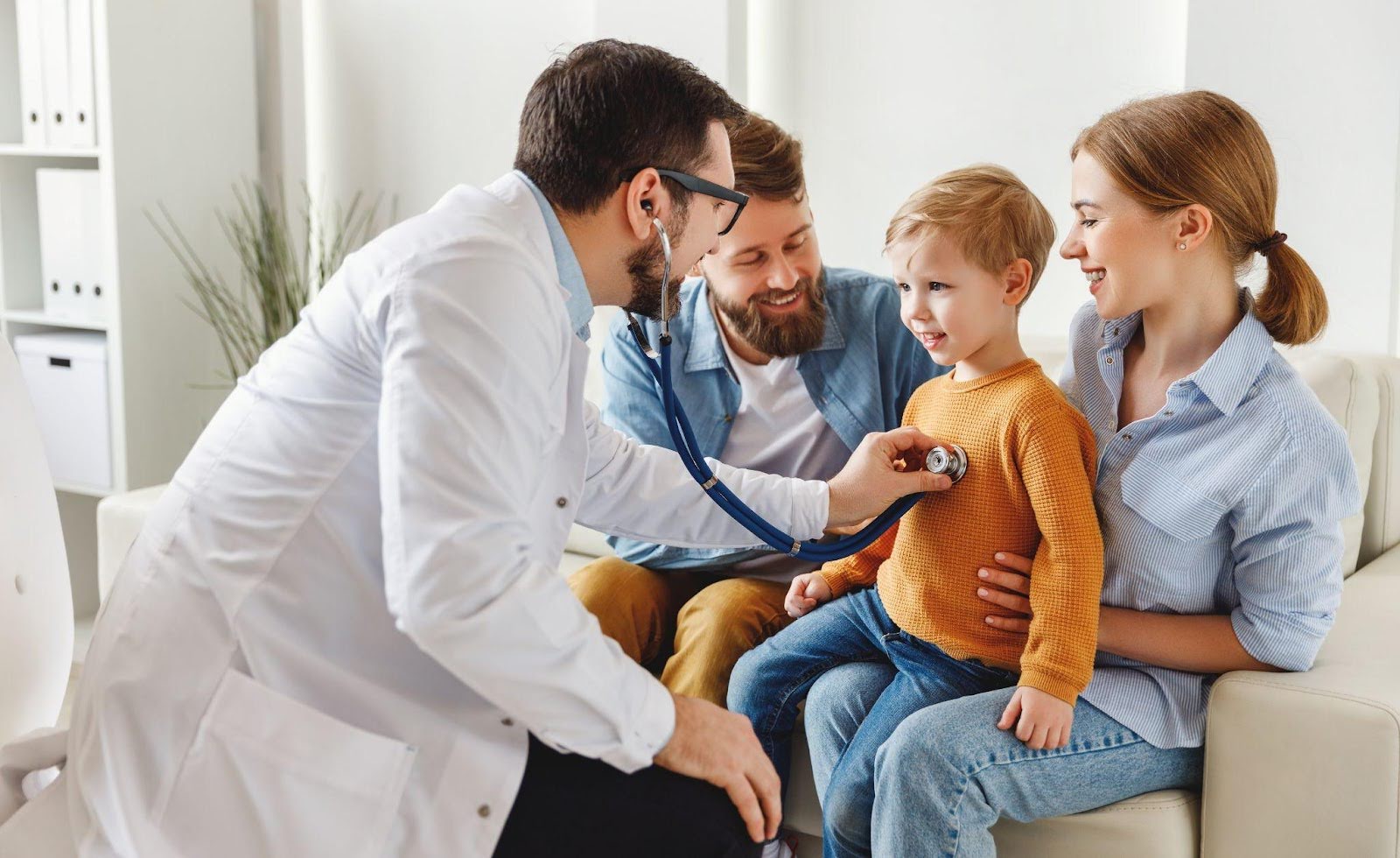 A doctor uses a stethoscope to examine a child during a medical check-up in a clinical setting
