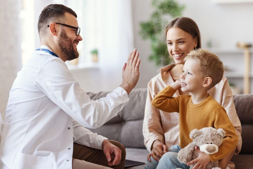 A doctor uses a stethoscope to examine a child during a medical check-up in a clinical setting