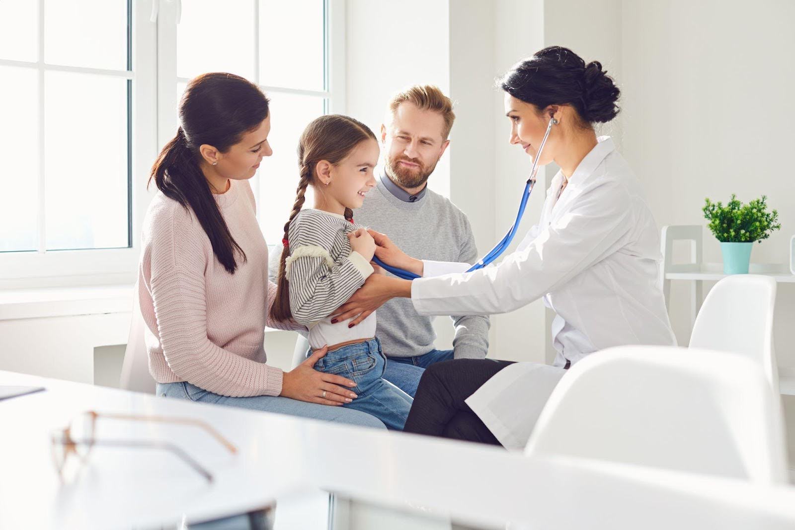 A doctor listens to a child chest with a stethoscope during a medical examination