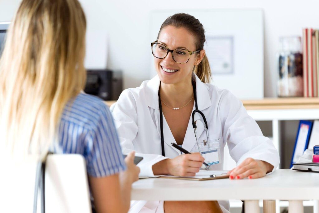 A female doctor discusses health concerns with a patient in a medical office setting